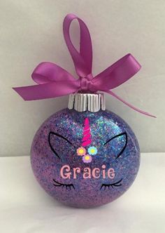 a purple glass ornament with a unicorn face and name grace on the front