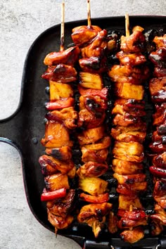 several skewers of meat on a grill with toothpicks