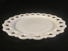 a white plate sitting on top of a black table