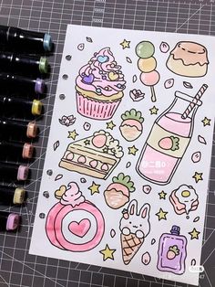 a sheet of paper with various stickers on it next to some markers and pens