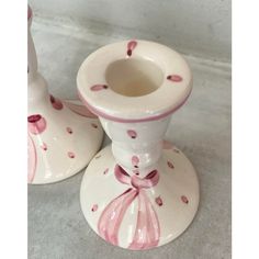 two pink and white candlesticks sitting next to each other