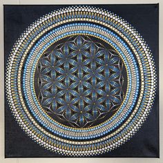 a blue and yellow circular design on black paper