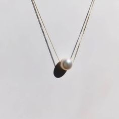 A beautiful, dainty floating pearl necklace made of 9ct yellow gold. The pearl is a genuine cultured freshwater pearl. It is 8mm in diameter and has been hand drilled to float on a 0.75mm delicate 9ct gold chain. Chain length can be chosen from the drop box at checkout. Pearl is the birthstone for June and so this stunning necklace would make the perfect gift for a June baby. Pearl also represents the 30th anniversary of a special bond and can be given as an anniversary present to signify the be Single Pearl Necklace Gold, Floating Pearl Necklace, Gold Minimalist Jewelry, Single Pearl Necklace, Drop Box, Tiny Diamond, Gold Ring Stack, Freshwater Pearl Necklace, Gold Diamond Earrings