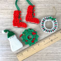 crocheted christmas ornaments are displayed next to a ruler