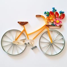 a bicycle made out of paper with flowers on the front wheel and side spokes