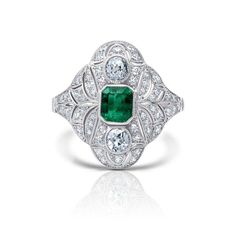 One of a kind handmade Art Deco platinum ring designed using 100% natural, genuine, and conflict-free Colombian emerald gemstone and diamonds. Not treated or enhanced in any way. Oiling only for emerald. This ring is embedded with a center Square Cut Cut Emerald and accented with two brilliant rose cut diamonds, and brilliant round cut diamonds. Unique and Stunning! Ring is independently certified and appraised by GIA Certified gemologists. Metal: Platinum 850 Dimensions: Weight: 5.5 grams Width: 18.3 MM Face of Ring Certificate: GGA Certified Emerald Details: Main Stone: Emerald Carat Weight: 0.41 CT Shape: Emerald Color/Clarity: Medium Green/VS, Type III, Eye Clean Cut: Excellent Certificate: GGA Nature: 100% Natural Emerald, Not Treated, Not Enhanced. Oiling only. Other Diamond Details Art Deco Emerald Ring, Columbian Emeralds, Jewellery Ring, Blood Diamond, Platinum Diamond Rings, Ring Art Deco, Ring Antique, Antique Roses, Deco Jewelry