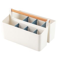 a white container with four compartments and a wooden handle