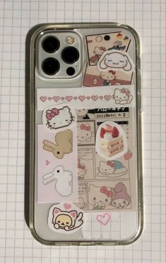 an iphone case with various stickers and pictures on the back, sitting on a table