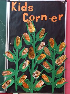 a bulletin board with corn on the cob written in orange and green letters that read, kids corner