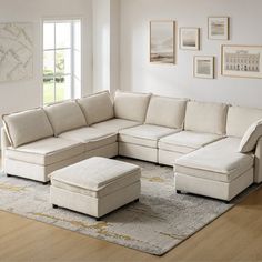 a living room with a sectional couch and ottoman