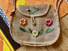 a purse with flowers on it sitting on a rug