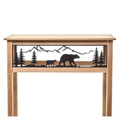 a wooden table with a bear and two cubs on the bottom, surrounded by mountains