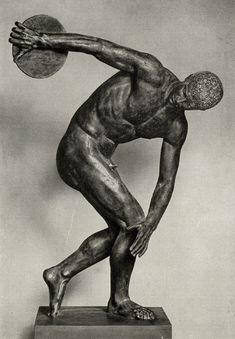 a bronze statue of a man holding a basketball