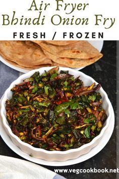 a white bowl filled with fried vegetables next to pita bread