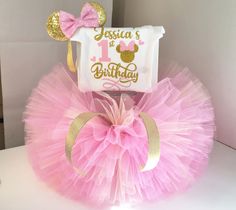 a pink and gold birthday tutu with minnie mouse on top