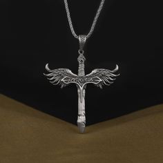 The Winged Sword of Michael the Archangel Pendant, 925 Sterling Silver Oxidized Religious Necklace, Christian Jewelry, Catholic Necklace Made of 925 silver and handcrafted by hand, this ring is not only an accessory piece that complements your daily elegance, but also has details that will reflect your character and style. It is also a great gift to give to your loved ones on their special days. At SavisSilver, we always give importance to the satisfaction of our customers, we recommend you to r Silver Winged Fantasy Jewelry, Silver Wing-shaped Fantasy Jewelry, Fantasy Silver Wing-shaped Jewelry, St Michael Necklace, Silver Fantasy Wing-shaped Jewelry, Eagle Spread Wings Necklace, Archangel Michael Necklace, Pegasus Necklace, Michael The Archangel