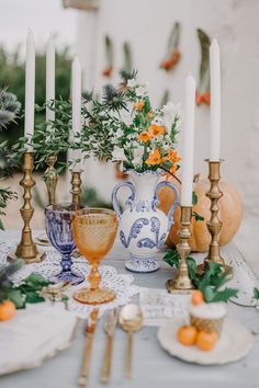 a table topped with lots of candles and plates