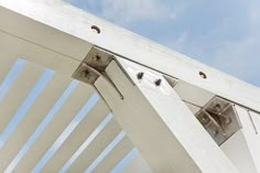 the top of a white wooden structure with two holes in it