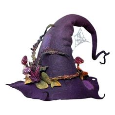 a purple witches hat with leaves and mushrooms on the top, sitting on a white surface