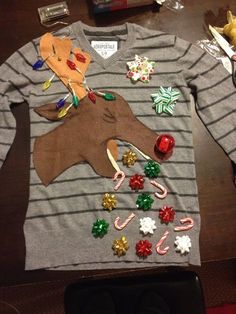 an ugly sweater is on the table with candy canes and candies all over it