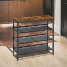 a kitchen island made out of metal and wood with three shelves on each side, in front of an oven