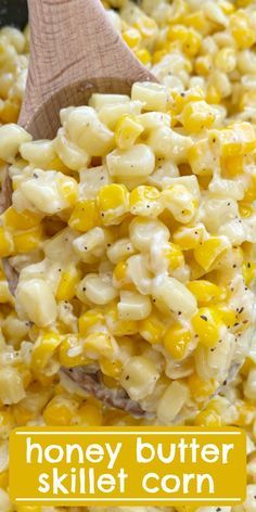 a wooden spoon in a bowl filled with macaroni and cheese on the side