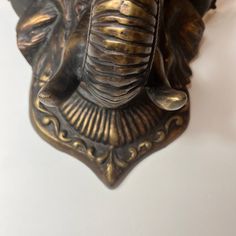 an elephant head is mounted on the wall