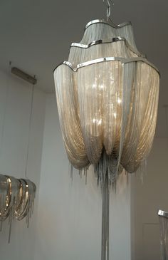 a chandelier hanging from the ceiling in a room with several lights on it