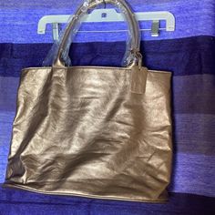 Brand New Neiman Marcus Rare 100 Anniversary Gold Tote Bag. Very Light Weight And Soft, Feels Like Genuine Leather But Can't See It Disclosed Anywhere. Lined In Beautiful Magenta (Hot Pink) Fabric Lining. Straps Still Covered In Original Wrapping And Long Enough To Go Over The Shoulder. Great Tote Especially To Carry Items To A Formal Occasion. 100 Anniversary, Hot Pink Fabric, Gold Tote Bag, Gold Anniversary, Pink Fabric, Womens Tote Bags, Formal Occasion, Burlap Bag, Neiman Marcus