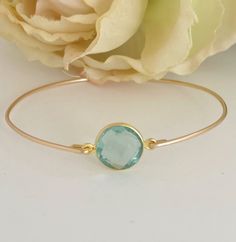 Aquamarine Bead Bracelet -  Aquamarine Bracelet - March Birthstone  A round faceted Aquamarine gemstone will be transformed into an elegant Aquamarine bangle bracelet with a gold filled bangle band. Perfect for a March birthstone bangle bracelet or the something blue for brides on their wedding day.  This March blue aquamarine jewelry can be personalized with an initial charm. Simply add to cart to make a customized aquamarine beaded bracelet; http://www.etsy.com/listing/84670605/add-an-initial- Adjustable Jewelry With Bezel Setting For Birthday, Stackable Round Jewelry For Birthday, Adjustable Gemstone Jewelry For Birthday, Adjustable Gemstone Jewelry For Birthdays, Bangle Jewelry With Bezel Setting For Gift, Adjustable Jewelry With May Birthstone, Adjustable May Birthstone Jewelry With Round Stone, Stackable Jewelry With Round Beads For Birthday, Round Birthstone Bracelets For Birthdays