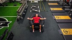 a man sitting on top of a bench in a gym