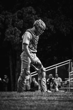 a baseball player standing on top of a field next to a catchers mitt