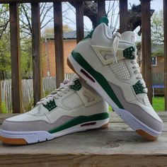 A pair of Air Jordan 4 Retro Pine Green sneakers with white leather, grey suede, and pine green accents. White Sole High-top Air Jordan 4, Leather High-top Air Jordan 4, Air Jordan 4 White Leather With Rubber Sole, White Leather Air Jordan 4 With Rubber Sole, White Jordan Shoes With Speckled Midsole, Casual Air Jordan 4 With Speckled Midsole For Streetwear, White Sole Jordan Shoes With Speckled Midsole, Leather Jordan Shoes With Speckled Midsole, Sporty Leather High-top Air Jordan 4