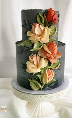 a three tiered cake with flowers on top