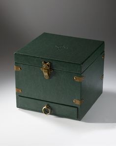 a green leather box with brass handles on a white background