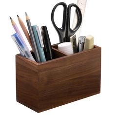 a wooden pen holder filled with office supplies