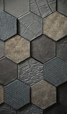 an abstract pattern made up of hexagonal tiles in grey and brown tones,