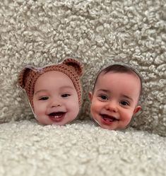 two babies are laying on a blanket with their faces reflected in the mirrors that show them smiling