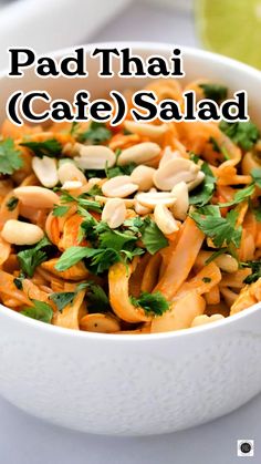 a white bowl filled with pasta and garnished with parsley in the middle