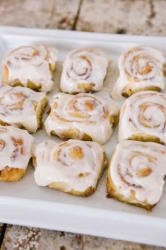 glazed cinnamon rolls on a white plate