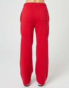 These sweatpants feature a mid rise waist, wide leg fit and an elastic waist. Streetwear Sweats With Elastic Waistband And Wide Leg, Streetwear Wide Leg Sweats With Elastic Waistband, Casual Wide Leg Bottoms With Ribbed Cuffs, Casual Wide Leg Sweats With Relaxed Fit, Casual Relaxed Fit Wide Leg Sweats, Spring Sweatpants With Straight Hem, Solid Color Straight Hem Sweatpants For Spring, Stretch Straight Leg Sweatpants For Elevated Casual, Casual Wide Leg Sweats With Elastic Waistband