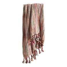 a multicolored scarf hanging from the side with tassels and beads on it