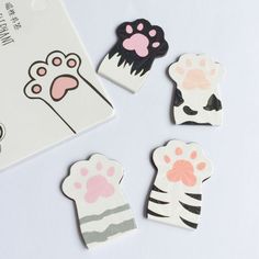 four different animal shaped magnets on a white surface with a tag in the middle