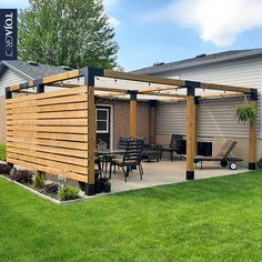 an outdoor patio with wooden pergoline and chairs