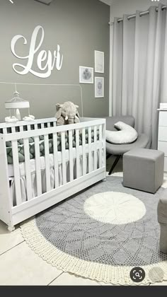 a baby's room with grey and white decor