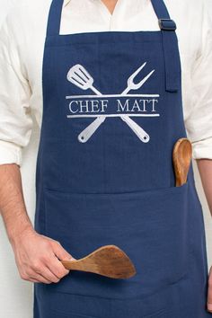 a chef holding a wooden spatula with two knives and fork in it's pocket