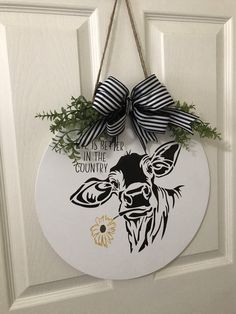 a door hanger with a black and white bow on it