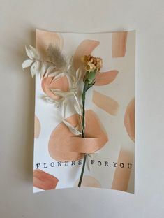 a flower is placed on top of a card