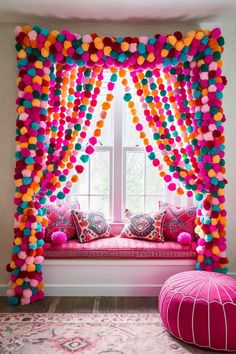 a window seat covered in pom - poms