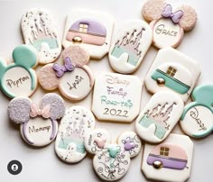 many decorated cookies are arranged in the shape of mickey mouses and minnie mouse ears